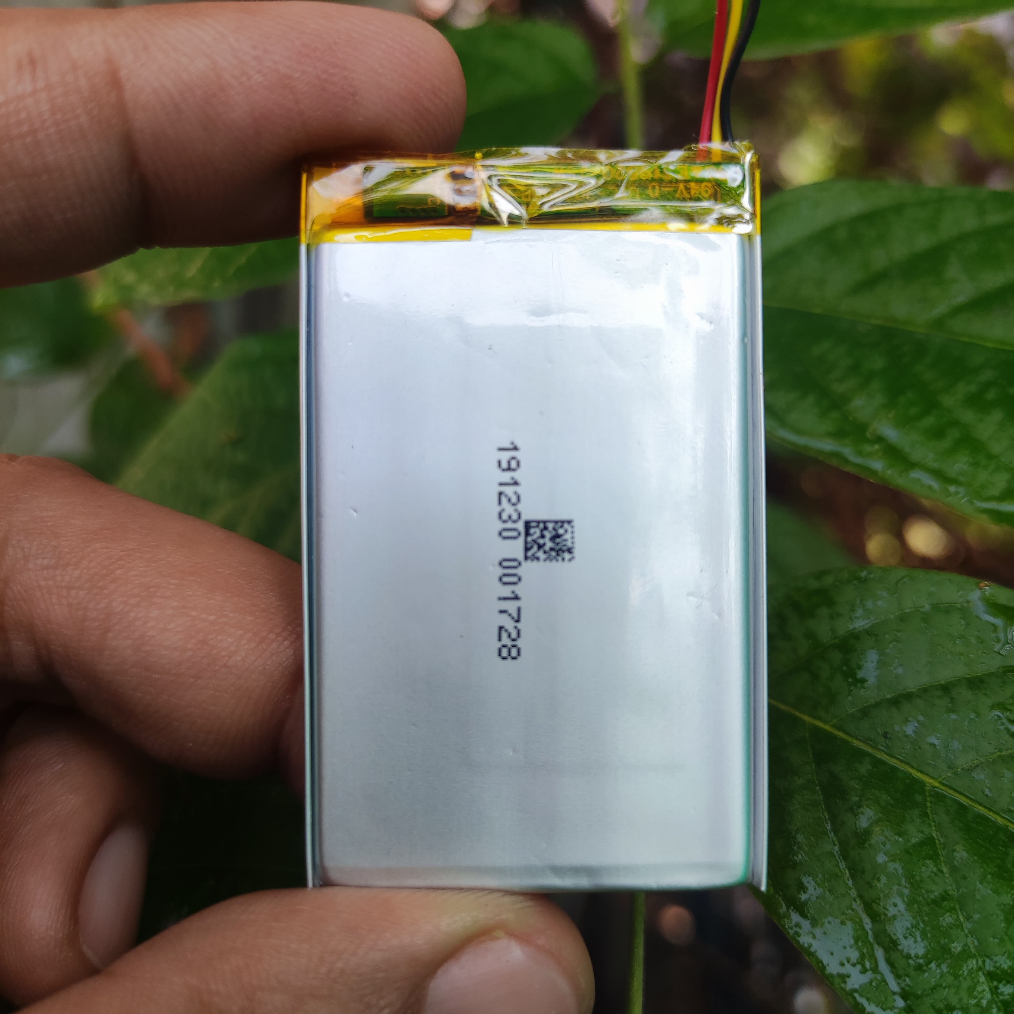 3mm x 35mm x 55mm 3.7V 500mAh Lithium Polymer Rechargeable Battery - shown as a silver rectangular cell held by fingers with a three-wire connector and a QR code label.