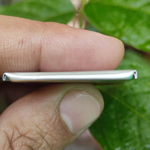 3mm x 35mm x 55mm 3.7V 500mAh Lithium Polymer Rechargeable Battery - a close-up side view showing the thin, rectangular silver-colored metallic casing held by fingers.