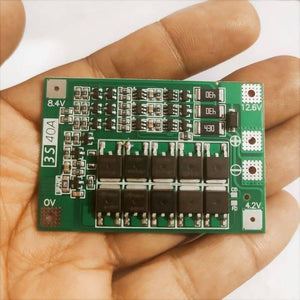 3s 40A BMS 11.1V 12.6V 18650 Lithium Battery Protection Board With 100mA Balancing Feature - a green rectangular circuit board with labeled voltage points 0V, 4.2V, 8.4V, and 12.6V held in a hand.