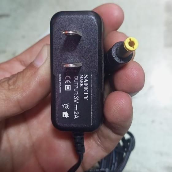3V 2A Adapter Charger for Geyser And Instant Geyser Gas - a black wall-plug power adapter with a yellow-tipped DC barrel connector held in a hand.