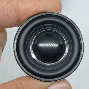 4 Ohm 3 Watt Speaker - a close-up view of a small circular black speaker with a metallic outer rim being held by fingers.