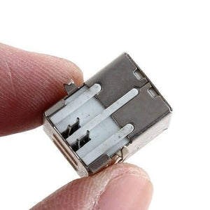 4 Pin USB b Type Socket Connector - a close-up shot of the silver and white rectangular metal connector held between two fingers.