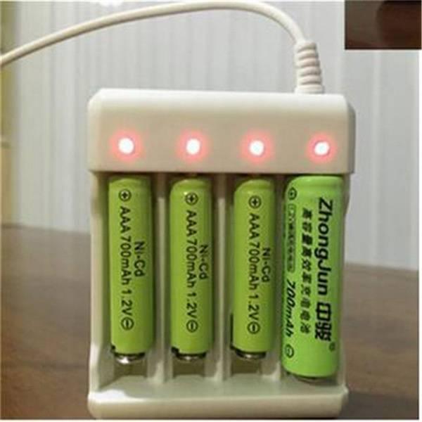 4 Slot USB Universal Battery Charger Fast Charging Adapter For Ni-MH Not For 18650 - with four green AAA 700mAh 1.2V Ni-Cd batteries inserted, showing four illuminated red charging indicator lights.