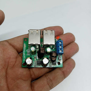4 USB Port A5268 Chip Step Down Transformer Converter Board Module DC 12V 24V 40V To 5V 5A 25W For MP3/MP4 Phone Car Equipment - a green circuit board held in a hand featuring two USB ports, a blue screw terminal, and an LED indicator.