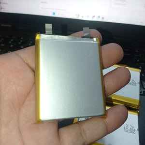4000mAh 3.7V Lithium Ion Battery Price 9.5mm X 54mm X 65mm - a rectangular silver pouch cell with two metal contact tabs held in a hand, with additional identical batteries visible.