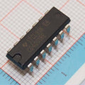 4001 Quad 2 Input Nor Gate IC - a black 14-pin dual in-line package integrated circuit resting on a grid-patterned surface.