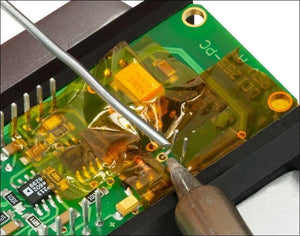 40mm Kapton Tape Polyimide Heat Resistant Tape - applied over a green circuit board while a soldering iron tip works on a component lead.