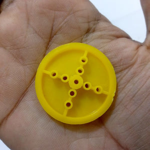 410 Wheel Tt Motor Arduino Smart Car Tyre Wheel Robot Tyre For Tt Motor - a close-up of the yellow plastic wheel showing its circular frame and central cross-shaped mounting holes.