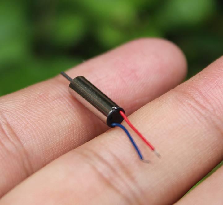 412 Coreless Motor DC3.7V Super Small Iron Boron Strong Small Motor Turn 72000 RpmCoreless Motor - silver cylindrical motor with a thin metal shaft and two thin red and blue wires held between two fingers.