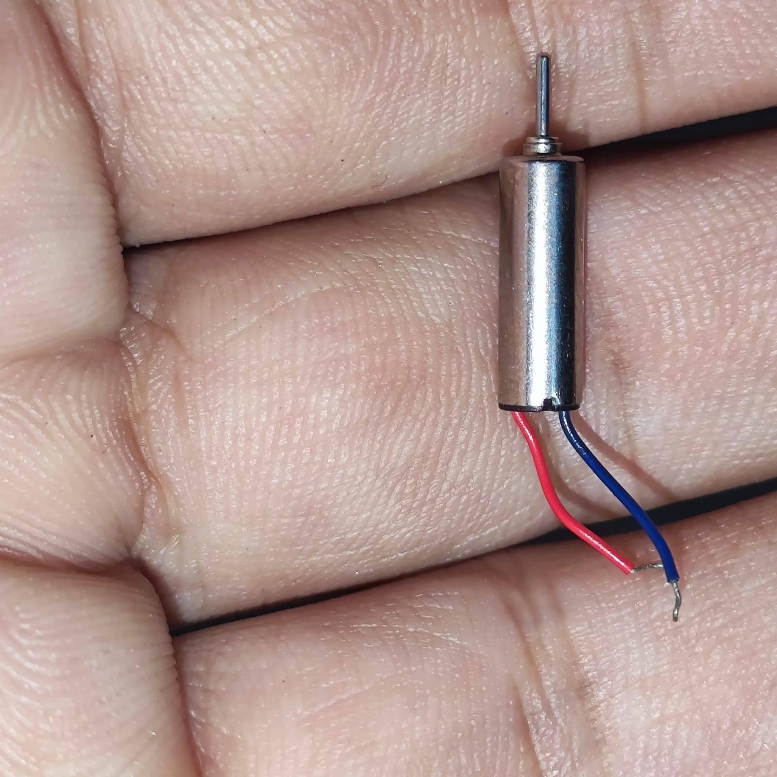 412 Coreless Motor DC3.7V Super Small Iron Boron Strong Small Motor Turn 72000 RpmCoreless Motor - silver cylindrical motor with a metal shaft and two thin red and blue wires, held in a person's palm.