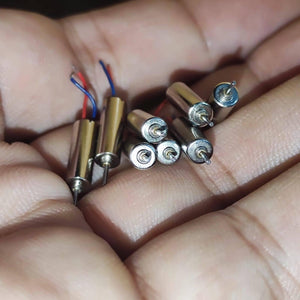 412 Coreless Motor DC3.7V Super Small Iron Boron Strong Small Motor Turn 72000 RpmCoreless Motor - close-up view of several small, cylindrical silver-coloured coreless motors held in a hand, with two showing wire leads.