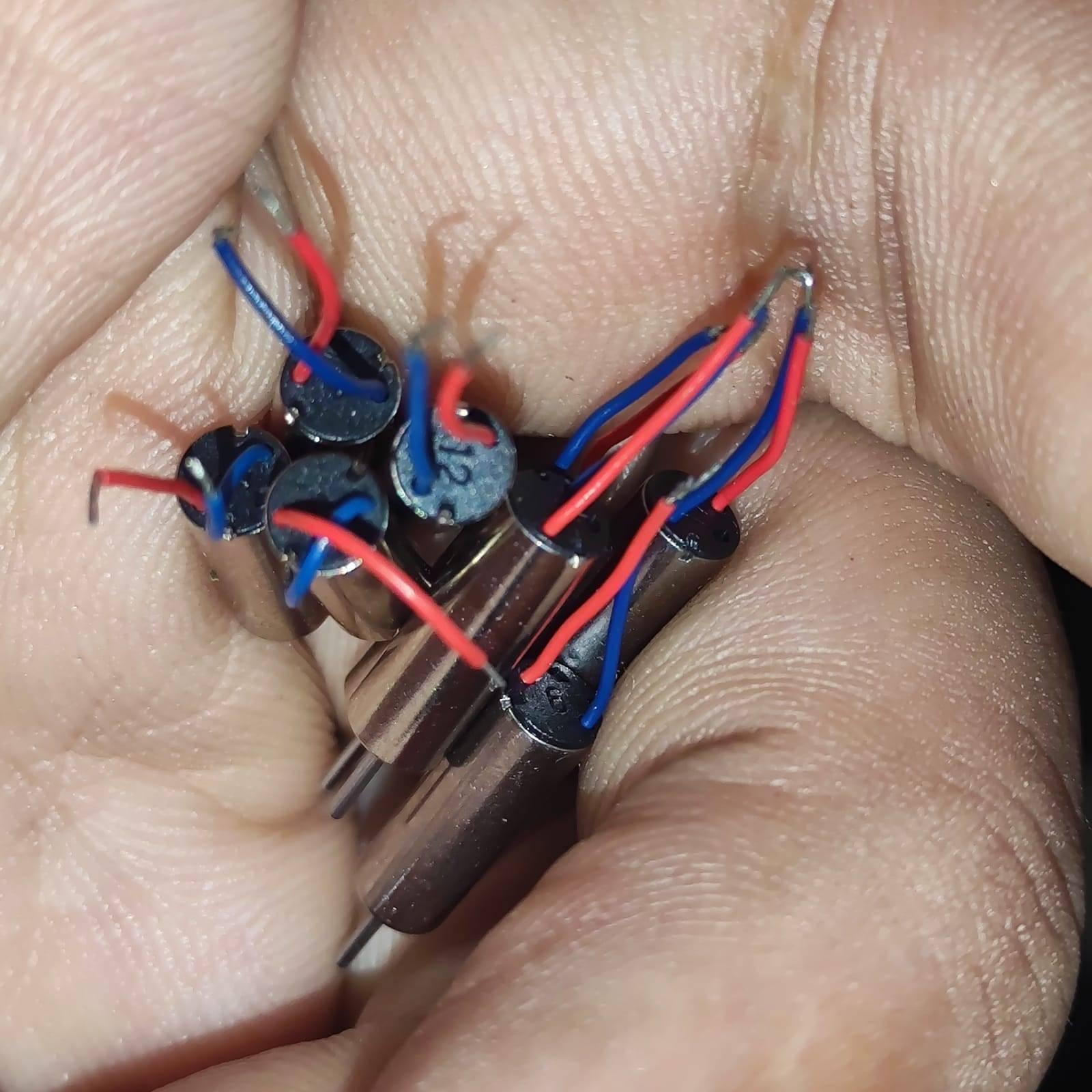 412 Coreless Motor DC3.7V Super Small Iron Boron Strong Small Motor Turn 72000 RpmCoreless Motor - a close-up of several small, cylindrical silver motors with red and blue wires held in a person's hand.