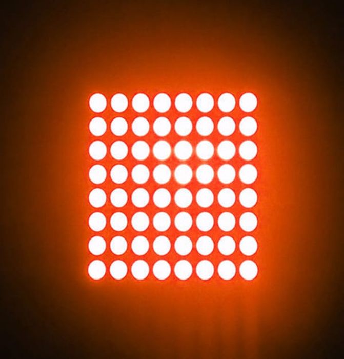 42MMX42MM 8x8 red dot matrix - an illuminated 8x8 grid of bright red circular LEDs against a dark orange background.