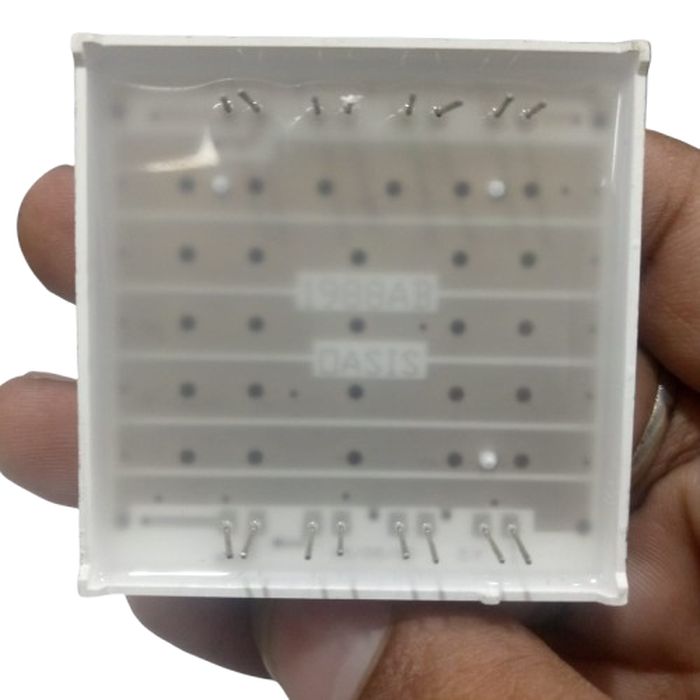 42MMX42MM 8x8 red dot matrix - a square LED display module with pins on the top and bottom, held in a hand.