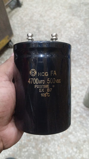 4700uF 500V Electrolytic Capacitor price - a large black cylindrical electrolytic capacitor with two screw-terminal connectors held in a hand.
