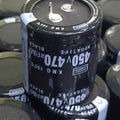 470uF 450V Capacitor For Local Inverter Manufacturing - a black cylindrical electrolytic capacitor with two top terminals, shown in a bulk storage tray.
