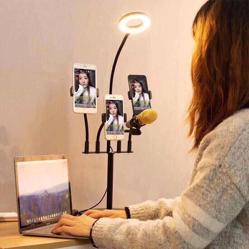 5 In 1 Multi Function Live Stream Support Kit - a black stand with a ring light, three phone holders, and a microphone mount in use.