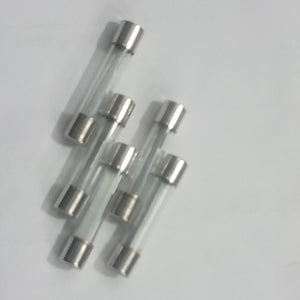 5 Pcs 6MMX21MM 35A Fuse - a group of five clear glass cylindrical fuses with silver metal end caps arranged on a plain white background.