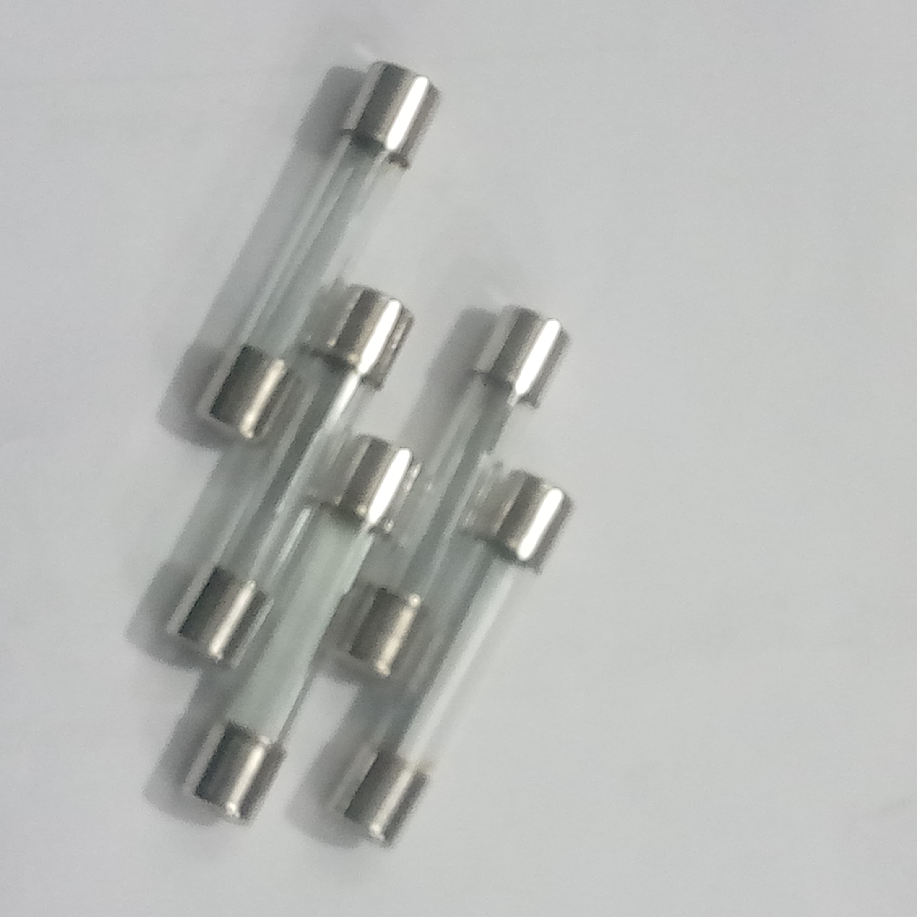 5 Pcs 6MMX21MM 35A Fuse - a group of five clear glass cylindrical fuses with silver metal end caps arranged on a plain white background.