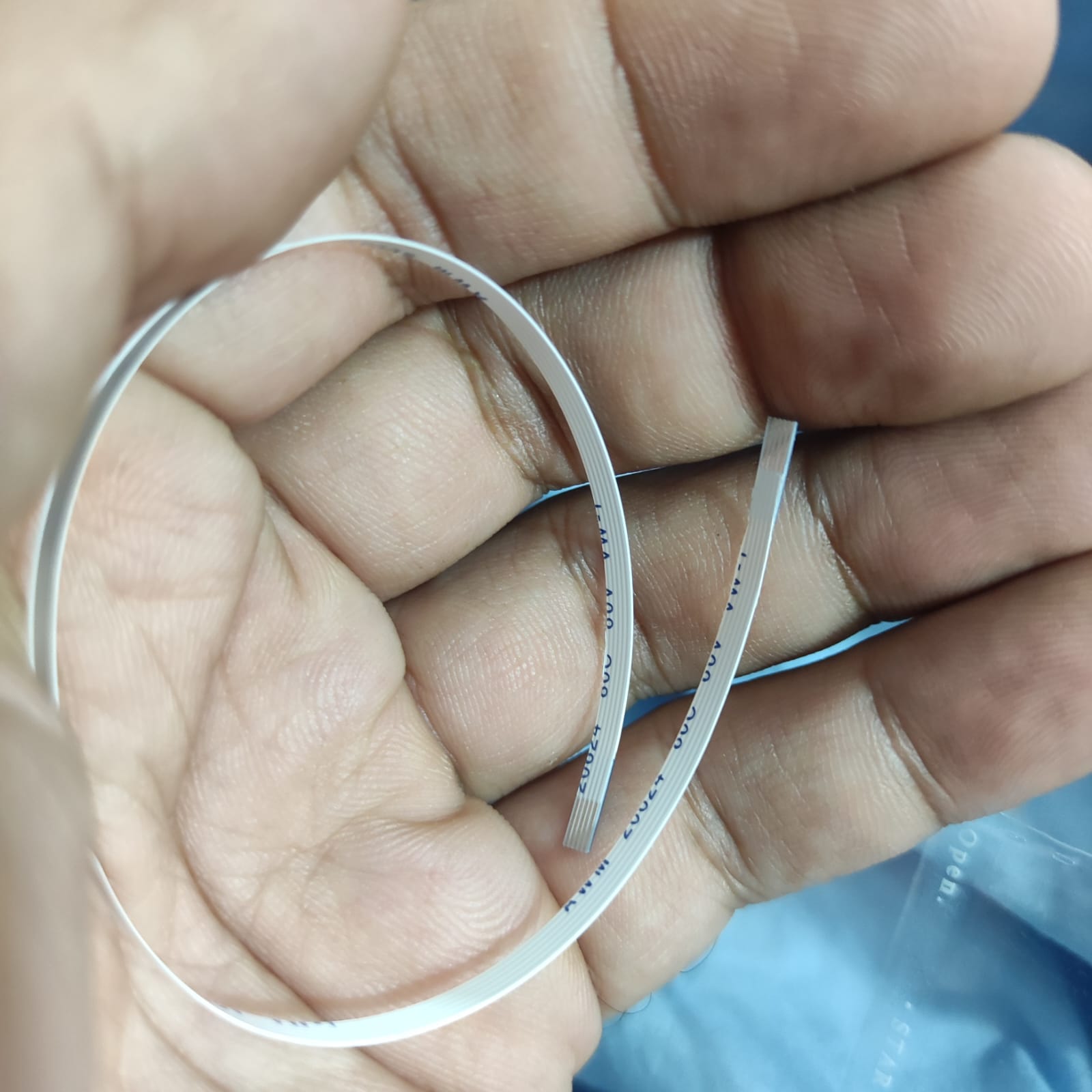 5 Pin Fpc Cable 0.5mm Pitch - shown as a close-up of the white flexible flat ribbon cable held in a hand.