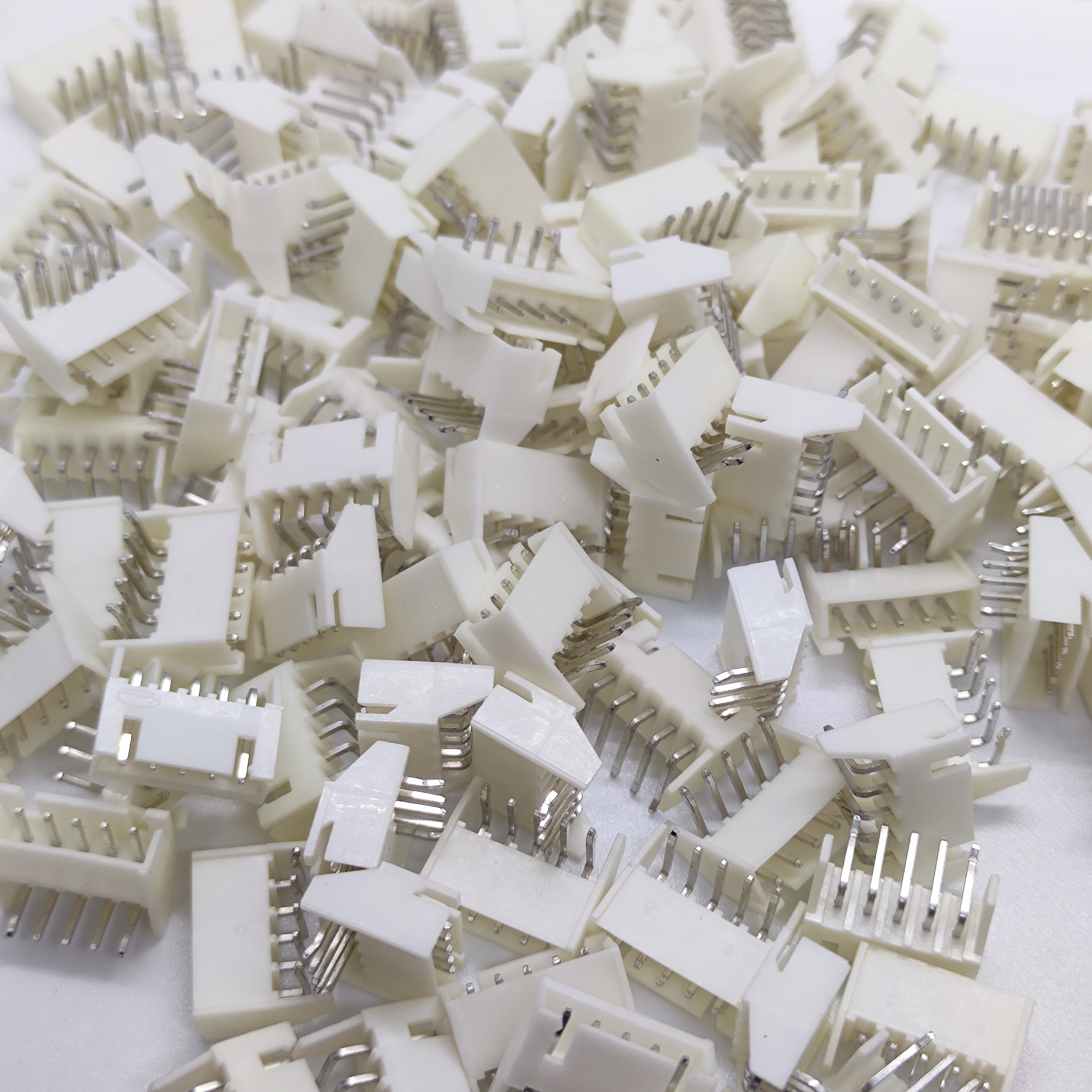 5 Pin Right Angle Male 2.5mm JST Xh Style PCB Mount Connector - shown as a pile of multiple white plastic electrical connectors with metal pins.