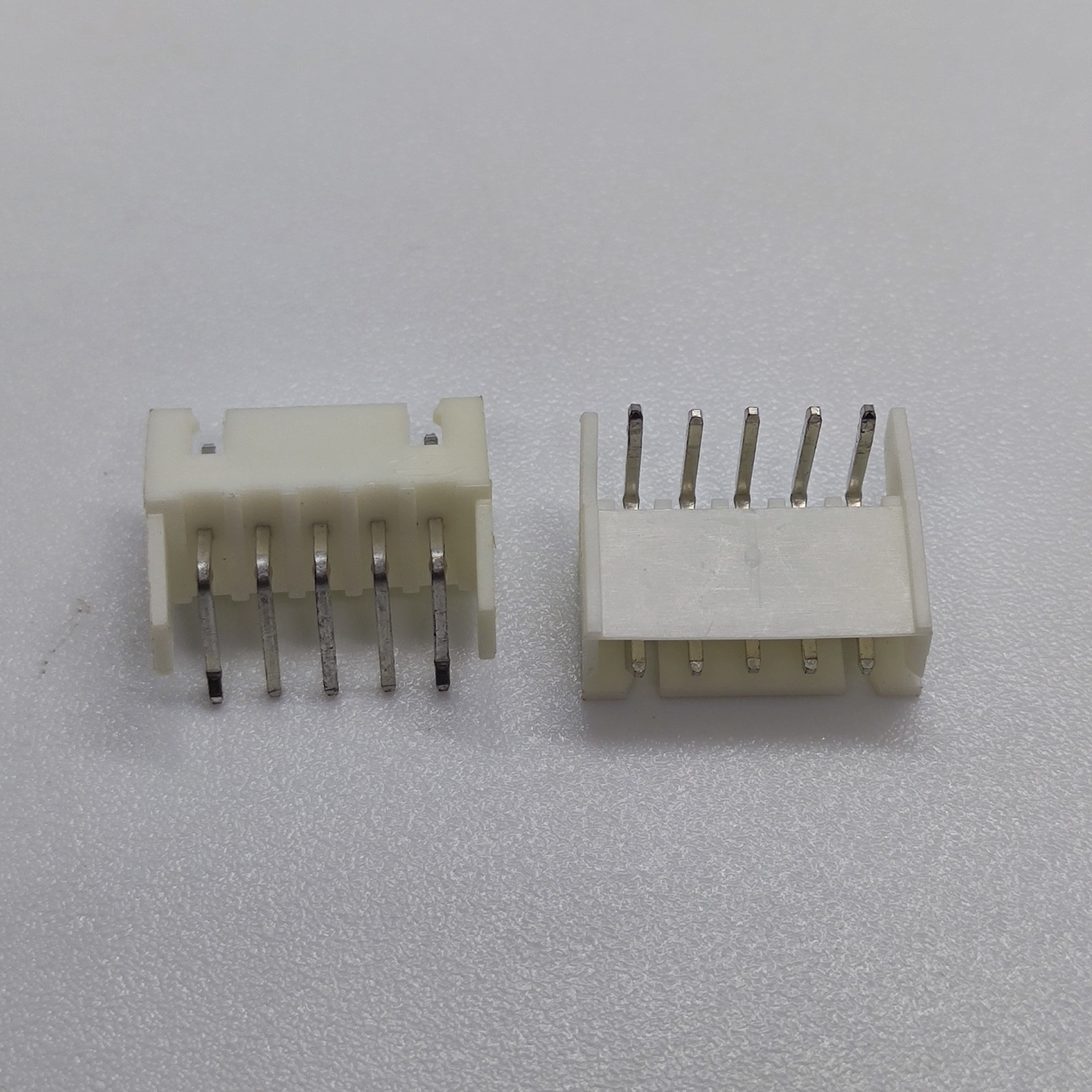 5 Pin Right Angle Male 2.5mm JST Xh Style PCB Mount Connector - shown as two white plastic components with five metal pins each, viewed from different angles.