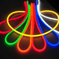 50 Meter 12V Neon Rope Light Red, Green Blue, White, Pink - arranged in a fan-shaped pattern of glowing, flexible LED neon strips on a white surface.