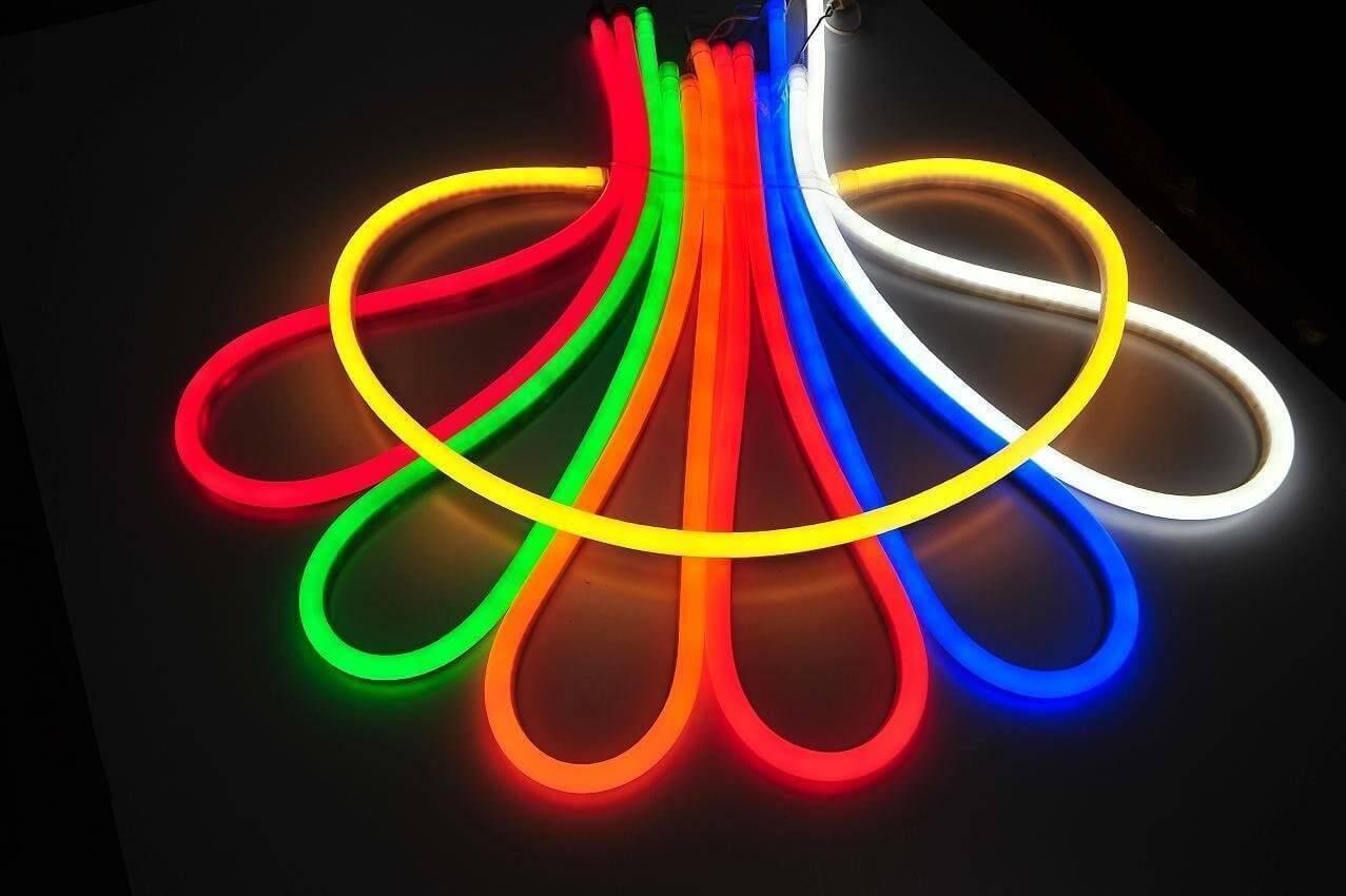 50 Meter 12V Neon Rope Light Red, Green Blue, White, Pink - arranged in a fan-shaped pattern of glowing, flexible LED neon strips on a white surface.