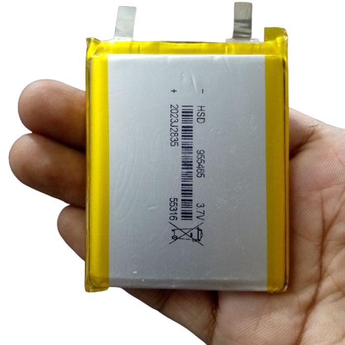5000mAh 3.7V Lithium Ion Battery Price - Lithium polymer pouch cell held in a hand, its silver face marked HSD 965465 and 3.7 V with two flat solder tabs at the top.