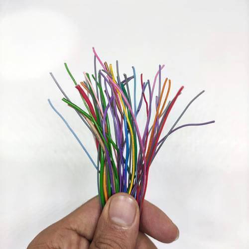 50GRM Multiple Size Flexible Wires Jumper Wire Solder Able Wires Different Colors Mix Length Used - a hand holding a bundle of thin, multicolored flexible jumper wires.