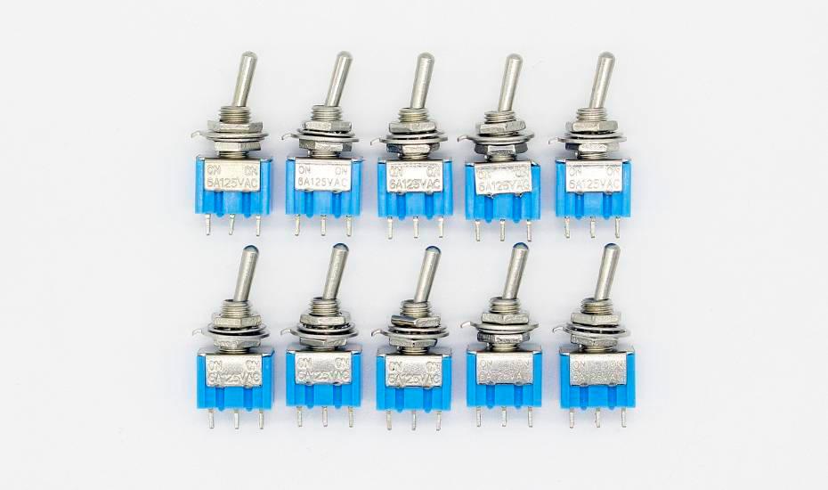5A 3 Pin Spdt Toggle Switch Spdt On Off - ten blue and silver toggle switches with three metal pins each, arranged in two rows of five on a white background.