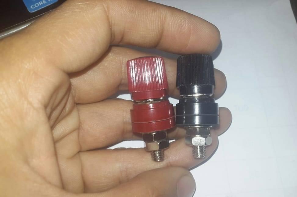 5mm Battery Terminal Stud Remote Battery Binding Post Power Junction Connector Terminal Kit 1 Pair Black + Red - one red and one black post held in a hand.