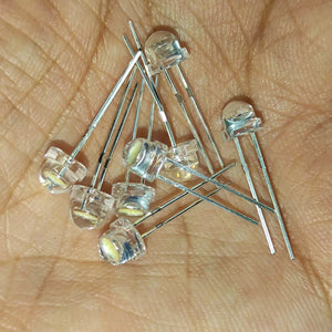5mm F5 Straw Hat LED White - High Power, Ultra Bright Indicator Light For DIY Projects (0.5W, 3-3.2V) - a close-up of several clear, dome-shaped LEDs with two metal pins held in a person's palm.