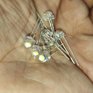 5mm F5 Straw Hat LED White - High Power, Ultra Bright Indicator Light For DIY Projects (0.5W, 3-3.2V) - a close-up of several clear, dome-shaped LEDs with two metal pins held in a person's palm.