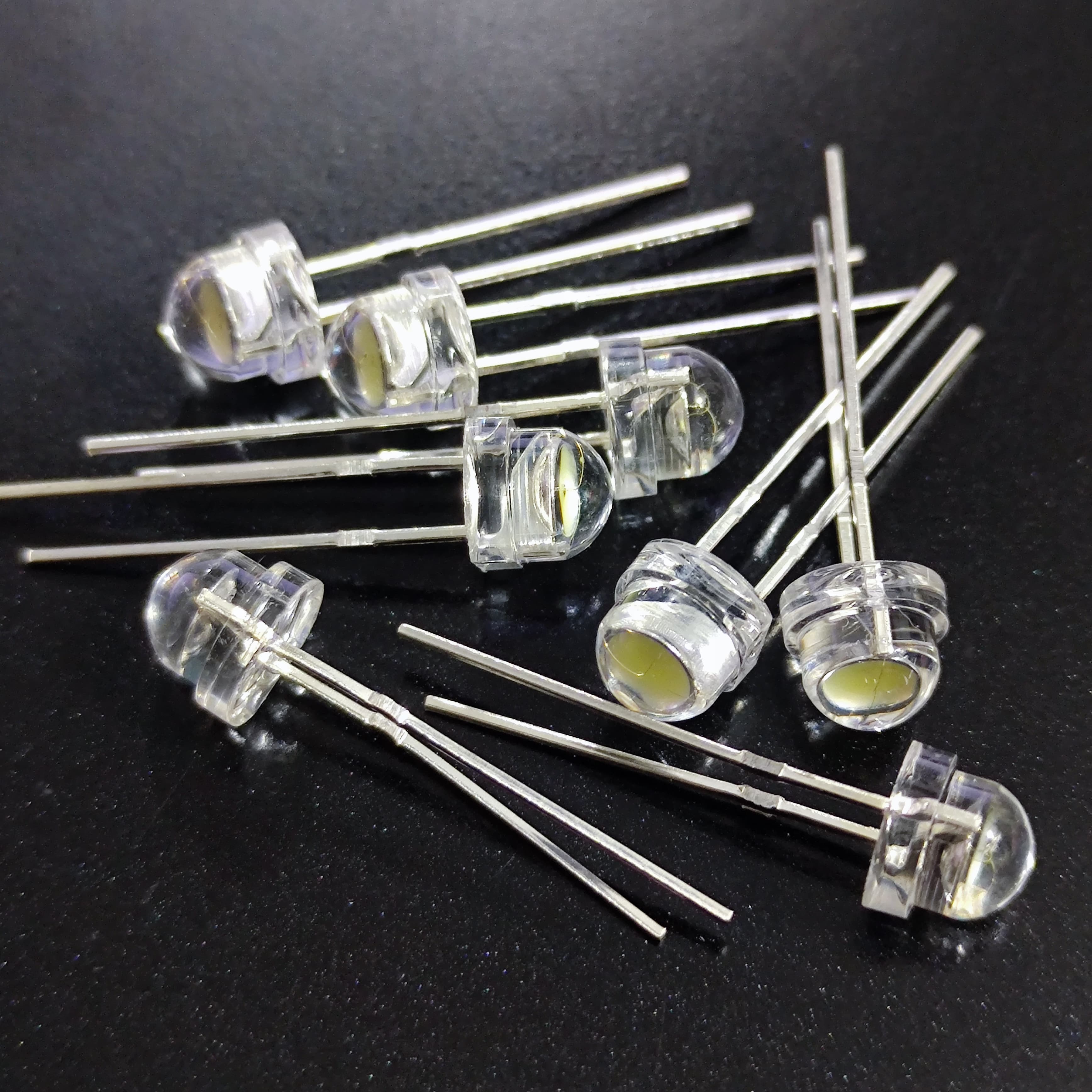 5mm F5 Straw Hat LED White - High Power, Ultra Bright Indicator Light For DIY Projects (0.5W, 3-3.2V) - a small pile of clear, circular, flat-topped LED components with two thin metal pins extending from the base.