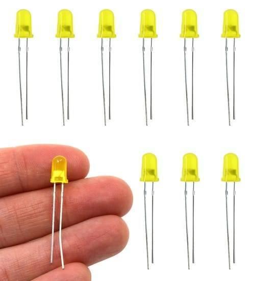 5mm Yellow LED Light Emitting Diode - shown as a collection of nine individual units with one being held between fingers to show scale.