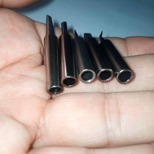 5pcs Lead-free Soldering Iron Tips - shown as a close-up of five metallic, hollow-ended soldering tips of varying shapes held in a hand.