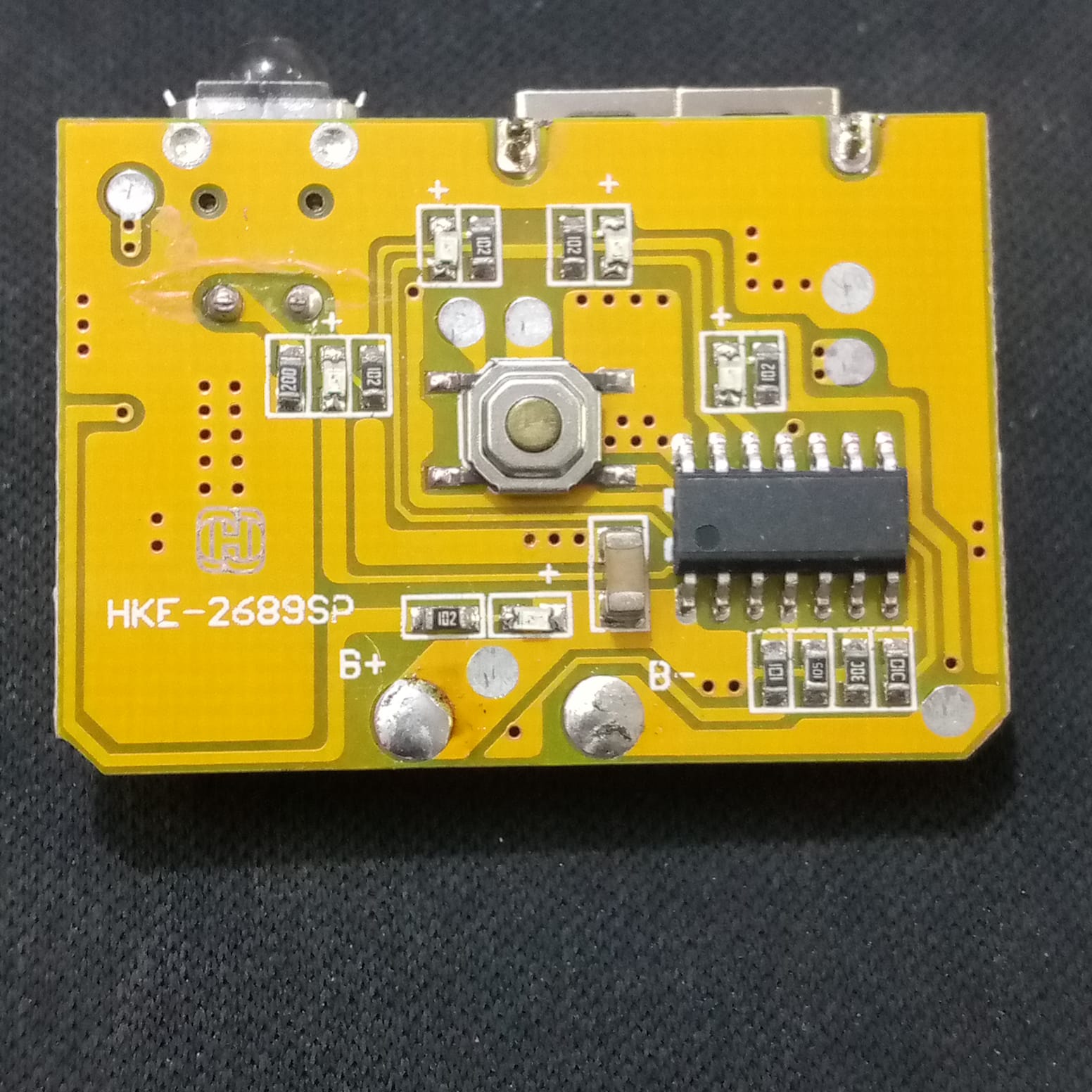 5V 1A Power Bank Charger Step Up Boost Charging Circuit Module - a yellow rectangular PCB with a button, USB port, and HKE-2689SP label.