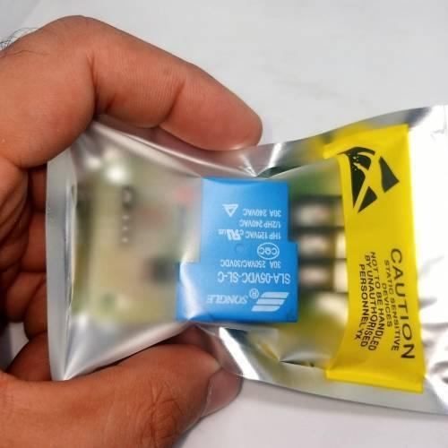 5V 30A Relay Module SLA-05VDC-SL-C - shown inside a silver anti-static bag with a yellow caution label, featuring a blue rectangular relay component.