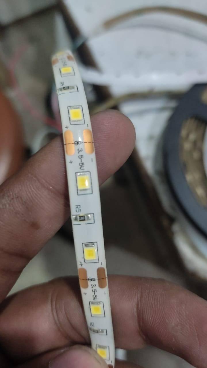 5V DC Strip Light Rolls 5 Meter Each - a close-up showing the white flexible LED strip with visible copper contact pads labeled 3.5-5V and resistors.