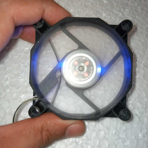 5V Fan With LED - a black square frame with a clear circular fan blade illuminated by blue light and a central hub with four visible copper coils.