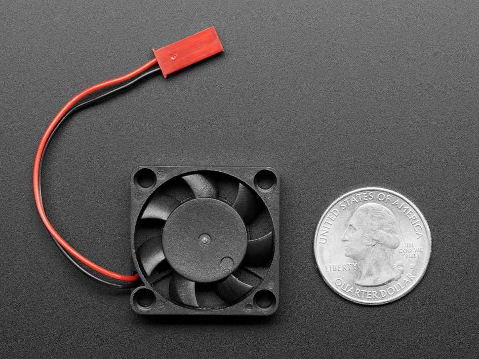 5V Raspberry Pi 4 Fan - a small black cooling fan with a two-wire red connector, shown next to a US quarter coin for scale.