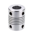 5x10mm Flexible Shaft | High-Quality Rotary Extension | Digilog.pk - silver-coloured cylindrical metal coupling featuring a central flexible spiral section and four small black set screws.