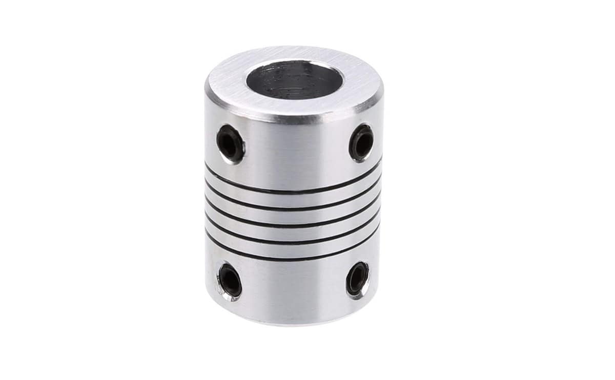 5x10mm Flexible Shaft | High-Quality Rotary Extension | Digilog.pk - silver-coloured cylindrical metal coupling featuring a central flexible spiral section and four small black set screws.