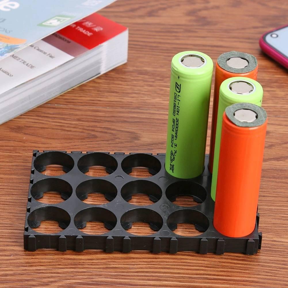 5x3 15 Cell 18650 Battery Spacer Radiating Holder Bracket With Lock For Electric Car Bike - with three cylindrical batteries inserted into the black plastic grid structure.