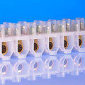 60 Amp Connector Strip, 12 Way PVC - shown as a single white plastic block with twelve metal-lined electrical connection ports arranged in a row.