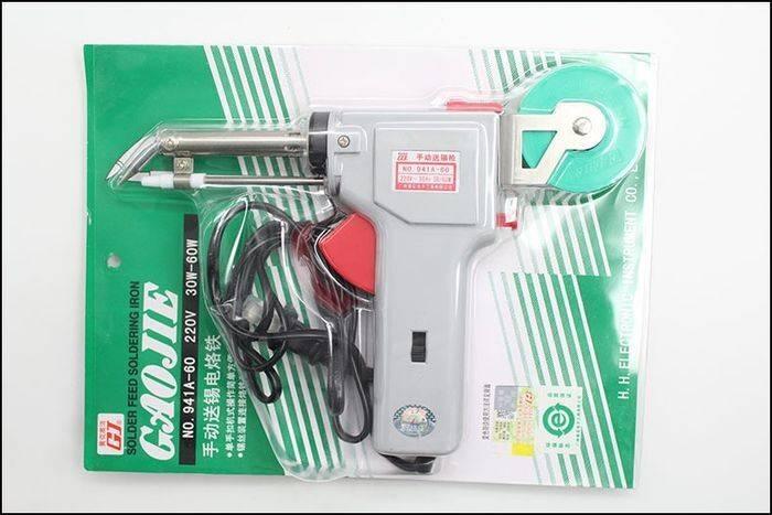 60W Manual Automatic Tin Welding Gun 941-60 Soldering Gun - a grey pistol-grip soldering iron with a green solder spool, sealed in its original retail blister packaging.