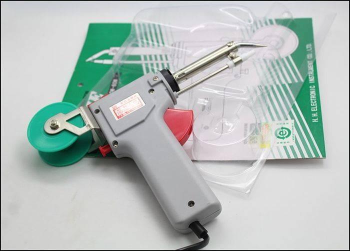60W Manual Automatic Tin Welding Gun 941-60 Soldering Gun - a grey pistol-grip tool with a red trigger, a green solder spool, and its original packaging.