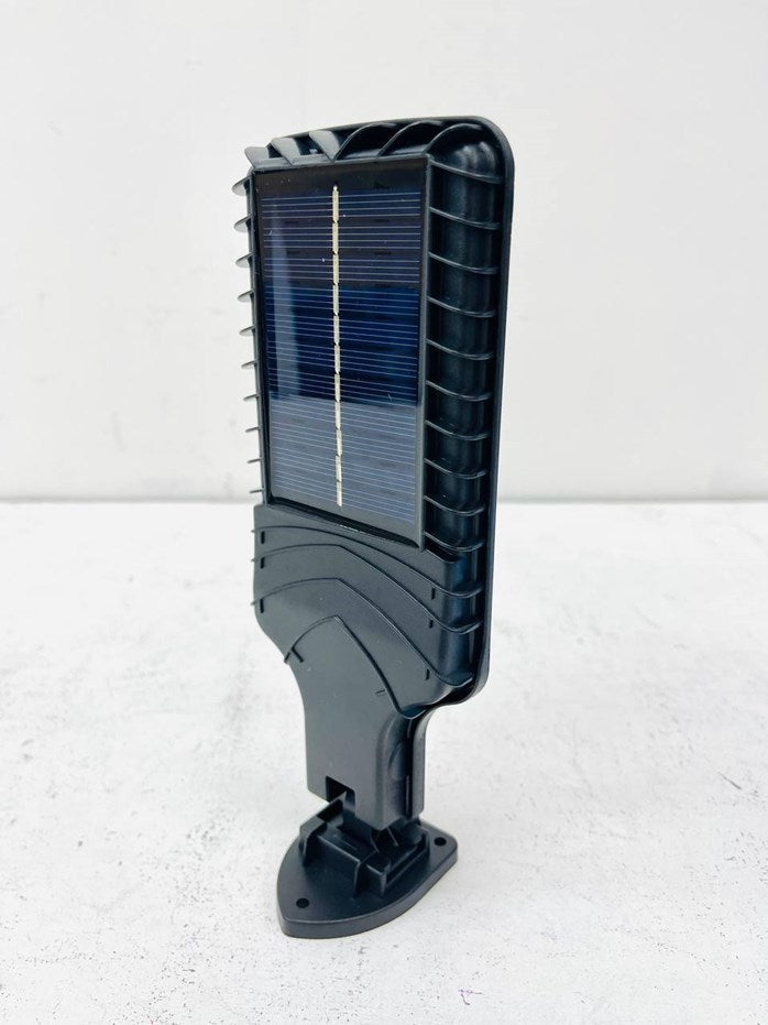 616-4 Motion Sensor Street Lamp - a black plastic solar-powered light fixture with a rectangular solar panel on the front and a mounting base at the bottom.