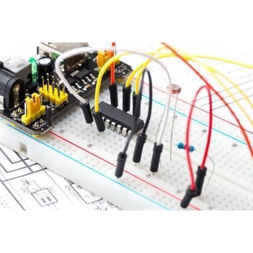 65pcs Jump Wire Cable Male To Male Jumper Wire For Arduino Breadboard 1 Bag - various coloured jumper wires connected to an integrated circuit on a breadboard.